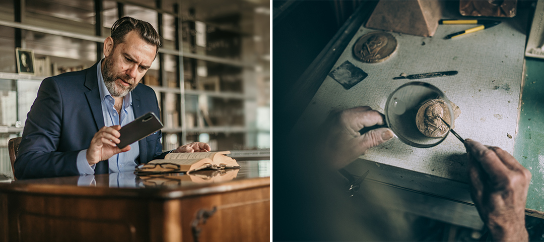 This split image shows two aspects of art and artifact authentication work. On the left, a well-dressed man with a beard in a navy suit and light blue shirt sits at a wooden desk, taking a photo of an open book or document with his smartphone. His focused expression suggests he's documenting or researching something important. On the right, a close-up shows hands working with fine tools on what appears to be a small artifact or medal in a shallow dish, likely engaged in restoration, authentication, or detailed examination. The workspace contains various tools and materials scattered around. Together, the images illustrate both the research and hands-on aspects of working with historical objects or antiquities.