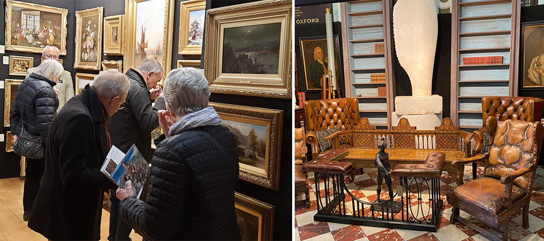 This image shows two side-by-side photographs of what appears to be an antique gallery or auction house setting. Left image: A group of elderly visitors with gray hair are examining framed artwork closely. They're dressed in dark winter clothing including puffy jackets and scarves, suggesting it might be cold. The visitors are looking at a wall densely hung with gold-framed paintings, primarily featuring landscapes and classical scenes. One person appears to be holding a brochure or catalog. The setting has wooden flooring and the paintings are displayed salon-style with multiple works stacked vertically. Right image: An elegant interior display of antique furniture and decorative arts. The scene includes several tufted brown leather chairs with worn patina, a decorative coffee table with what appears to be a small bronze figurine, and an ornate carved wooden piece that might be a fireplace surround or architectural element. In the background are built-in bookshelves filled with books, and a large white sculptural form (possibly alabaster or marble) sits atop a pedestal. The floor appears to be a patterned marble or tile surface.