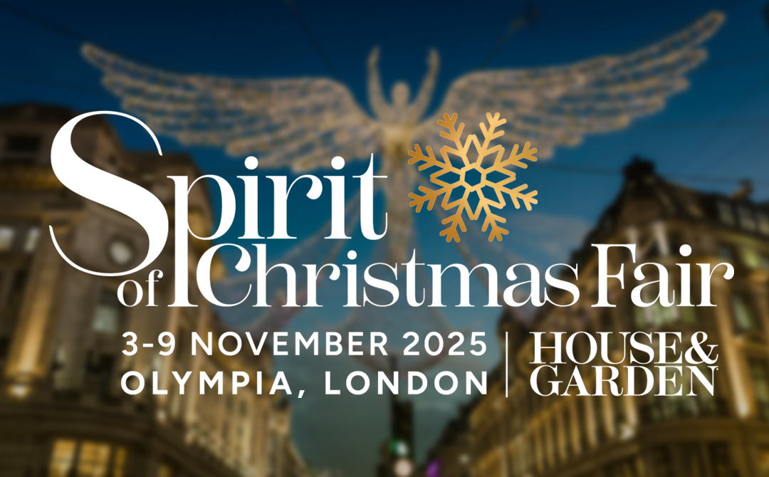 Spirit of Christmas Fair logo with golden snowflake design over a blurred background of classical architecture. Text reads 'Spirit of Christmas Fair, 3-9 November 2025, Olympia, London' with House & Garden branding.