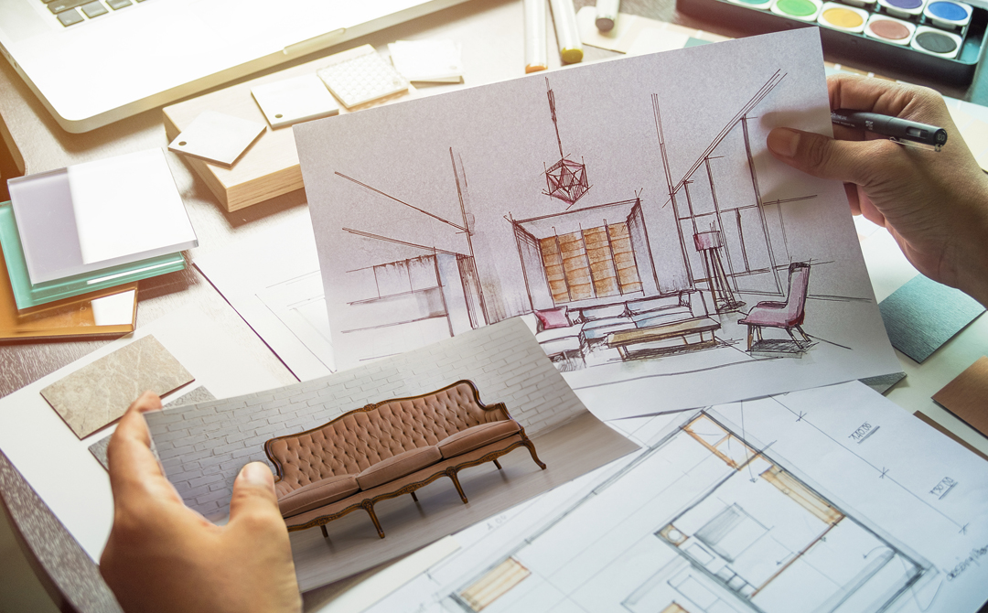 Interior designer holding a sketch of a modern living room and a photo of a vintage tufted sofa, planning how to integrate antiques into a contemporary space.