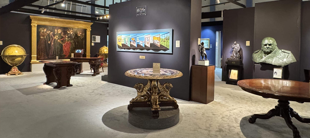 Exhibition hall at The Palm Beach Show with fine art, historic furniture, and sculpture displayed in a contemporary gallery-style booth layout.