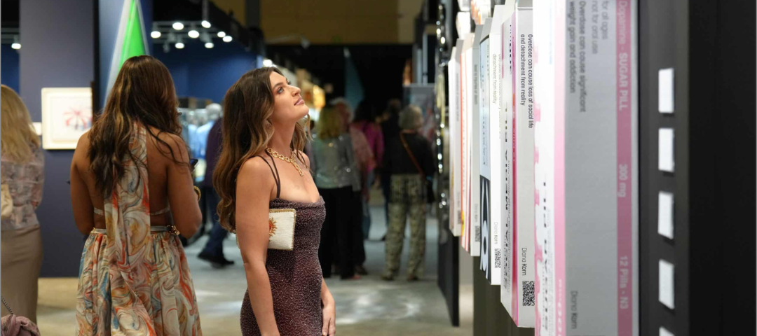 Visitor viewing contemporary artwork at The Palm Beach Show in Florida.