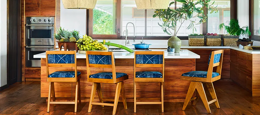 A kitchen with wood cabinetry, woven textures, and vintage-style stools, blending contemporary design with natural materials and collected elements.