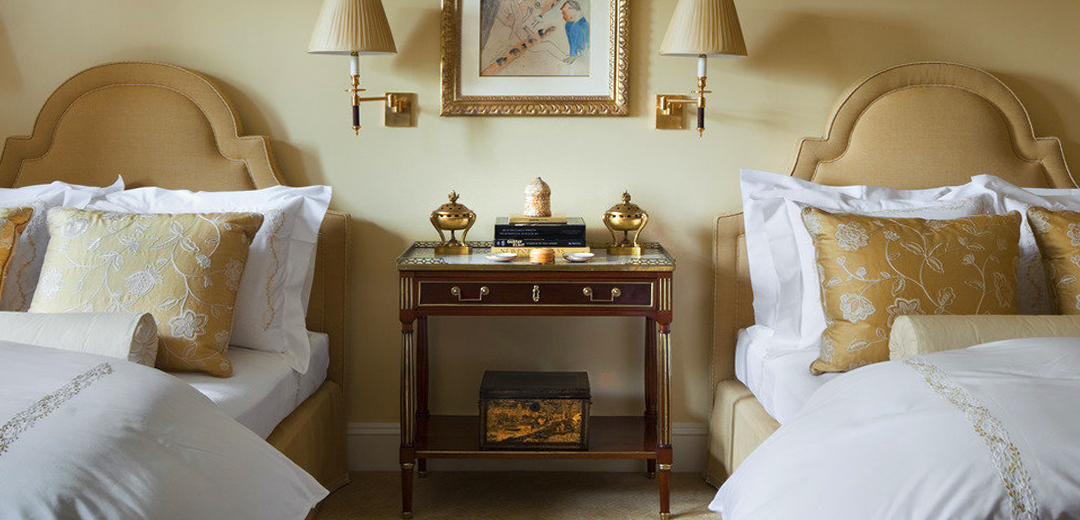 Elegant guest room featuring antique furnishings and layered decorative elements, demonstrating how historic objects bring depth, character, and continuity to contemporary interiors.