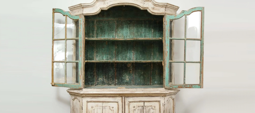 Swedish glazed display cabinet with white painted exterior and turquoise-painted interior, doors open.